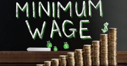 minimum wage text with stacks of quarters